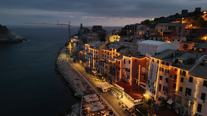 Drone view of illuminated Portovenere at night along the Ligurian coastline in Italy