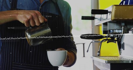 Pouring barista in dark apron blue-shirt foaming milk from jug into cup by espresso machine, data