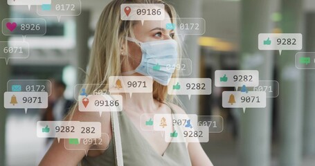 Standing woman wearing surgical mask, sleeveless top, bag strap in terminal, with AR icons floating