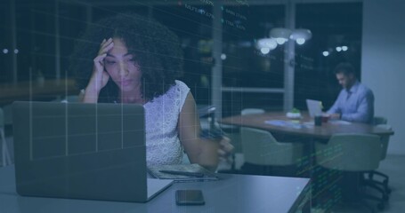 Typing woman in lace top rubbing forehead at night office, with laptop smartphone and data overlay