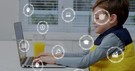 Typing kid in yellow vest grey top using laptop at home, orange-juice, digital-icons, copy space