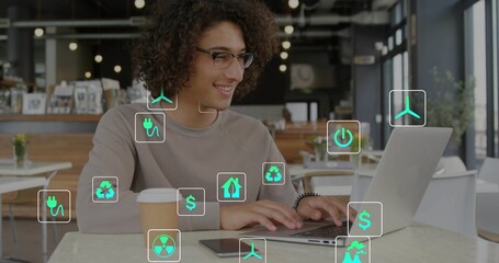 Typing adult male wearing tan longsleeve sweater at cafe, with laptop, coffee cup, green tech icons © vectorfusionart