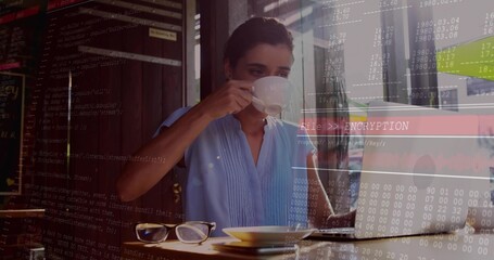 Sipping woman in blue top holding cup, eyeglasses, typing on laptop at cafe window, ENCRYPTION text