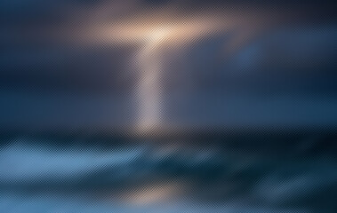 Textured glass surface. Light reflects and refracts through the patterned material, creating a gradient of blue, purple, and soft golden hues.