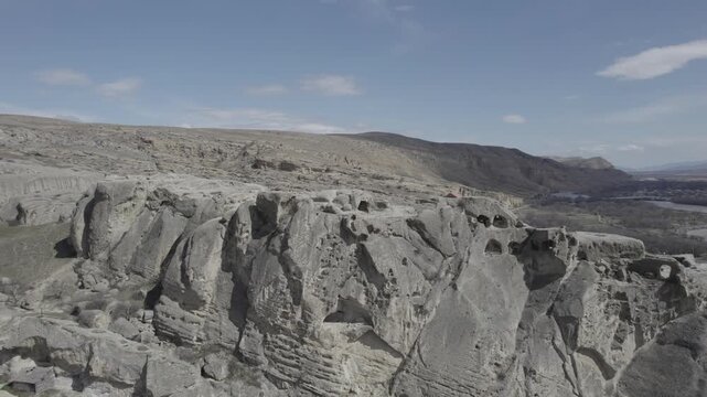 High-altitude aerial view of the Uplistsuli Church of the Prince in Uplistsikhe, an ancient rock-hewn town near Gori, Georgia, highlighting historic stone architecture.