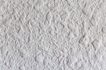Obraz premium Primer plano de pared blanca de estuco o yeso con textura irregular, hendiduras y acabado mate.Primer plano de pared blanca de estuco o yeso con textura irregular, hendiduras y acabado mate.
