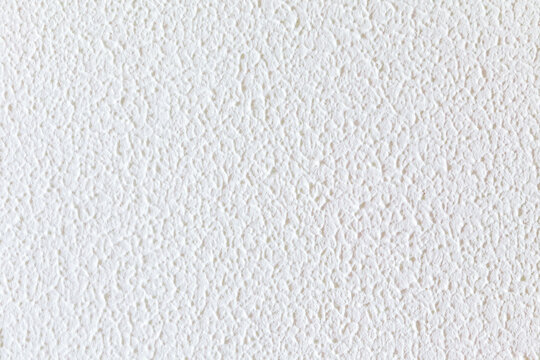 Primer plano de pared blanca de estuco o yeso con textura irregular, hendiduras y acabado mate.Primer plano de pared blanca de estuco o yeso con textura irregular, hendiduras y acabado mate.