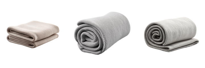 Three folded and rolled soft textured blankets in neutral tones isolated on a transparent background