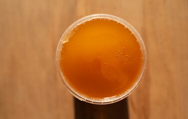 jar of natural honey, top view, wooden background, copy space