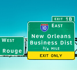 Urban street scene in New Orleans with multiple directional road signs © jovannig