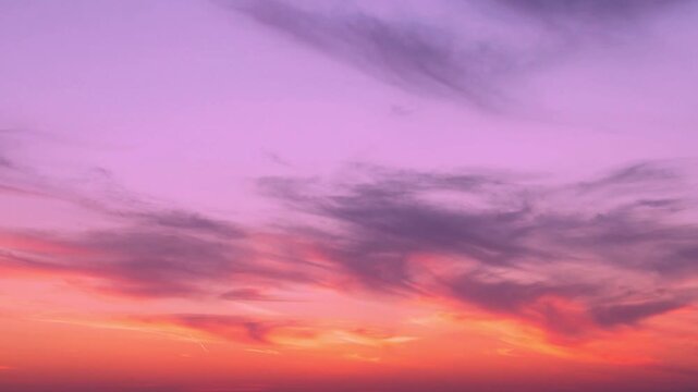 Bright multi colored sunset sky sun and gentle colorful clouds fast time lapse horizon. Beautiful fantasy colorful skyscraper sun and cirrus clouds, timelapse horizon beautiful background 4K.