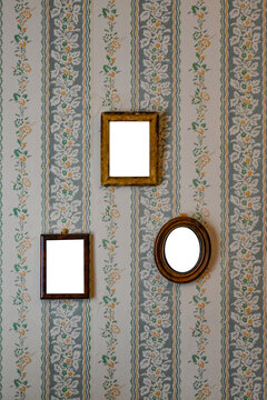 Blank vintage frames on old wallpaper room