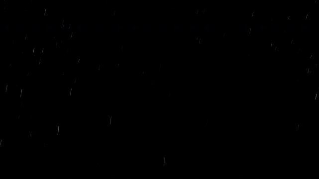 Super slow motion of natural snow falling on black background