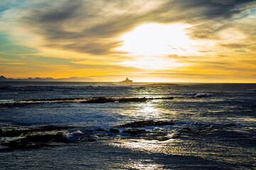 Obraz premium Golden Sunset Over Ocean With Ship on the Horizon, Iceland