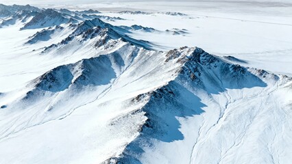 Aerial view of snow-covered mountain peaks in a polar region