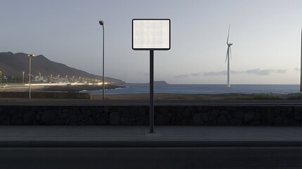 Illuminated billboard by the sea with wind turbine and coastal town in background, ultra hd photo