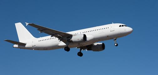 The plane lands.Airplane, passengers flying in the blue sky, preparing to land at the airport	