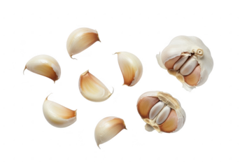 Fresh garlic cloves and bulbs scattered on a black background