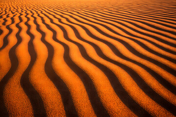 Sand dunes with wave patterns in desert