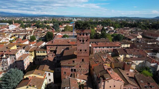 Aerial 4K Drone Orbit of Guinigi Tower with Hanging Garden Trees on Top in Lucca Tuscany &mdash; Iconic Medieval Architecture and Cityscape Panorama