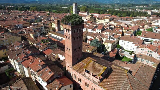Cinematic Orbit Flight around Guinigi Tower: Iconic Medieval Brick Tower with Holm Oaks on Top, Lucca Tuscany Italy