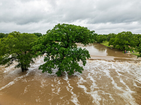 Aerial view of flooding in Georgetown Texas after heavy rainfall in July 2025 showing trees submerged and water over paths
