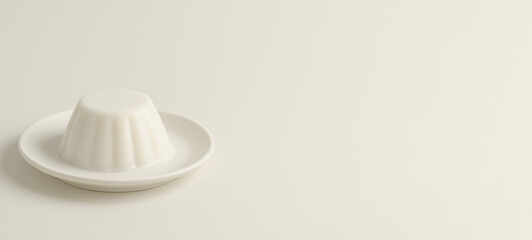 White ceramic jelly mold on plate against neutral background, copy space © dvoevnore