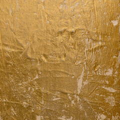 Abstract Textured Gold Venetian plaster Surface with Shimmering Highlights.