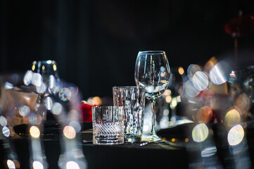 Romantic dinner setup at night. Table setting for couple, Valentine's Day evening, burning candles...