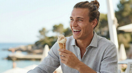 Young man laughing while enjoying ice cream cone by the beach  