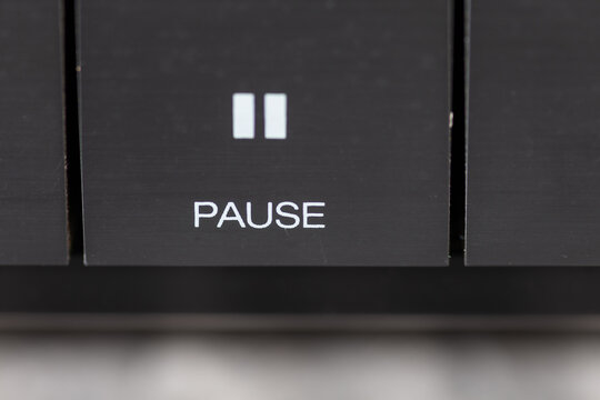 Close-Up Of Pause Button On Modern Stereo Panel With Metallic Finish