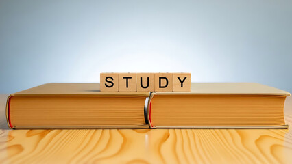 Stack of books with study text on wooden table background