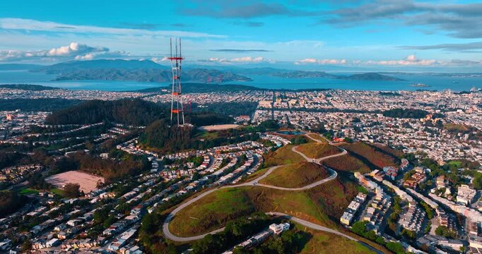 Approaching Sutro Tower in the picturesque green residential area. Flight over the green hills in San Francisco, California, USA.
