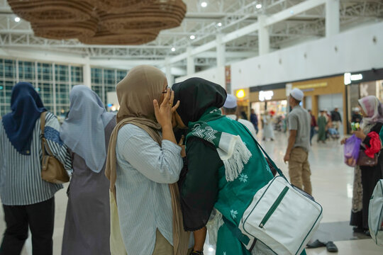 Elderly woman kissing her grandchild during a family farewell before an Umrah journey at Syamsudin Noor  Airport - Banjarbaru, Indonesia, Jan 17, 2026