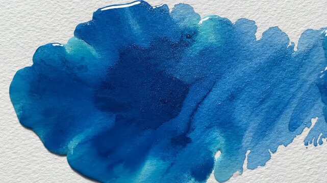 Abstract watercolor blue paint texture on white paper close up
