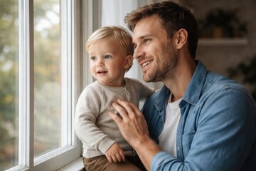 A joyful moment between a father and his young son, gazing out the window, capturing warmth and connection in a cozy setting.