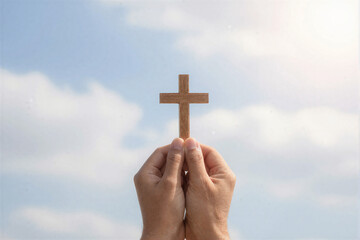 Hands lifting wooden cross toward bright sky