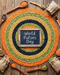 World Pulses Day concept with assorted dried legumes, lentils and beans arranged in circular pattern on rustic wooden table, healthy plant based protein and sustainable food