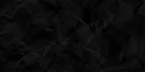 Black crumpled paper texture with folds, black background. black and white paper