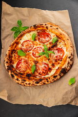 Pizza tomato margarita fast food natural product tasty snack fresh delicious gourmet food background on the table rustic top view copy space