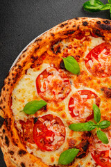 Pizza tomato margarita fast food natural product tasty snack fresh delicious gourmet food background on the table rustic top view copy space