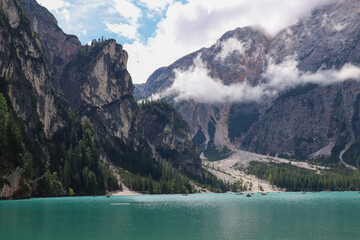 Crystal alpine lake with turquoise water beneath dramatic Dolomites mountains