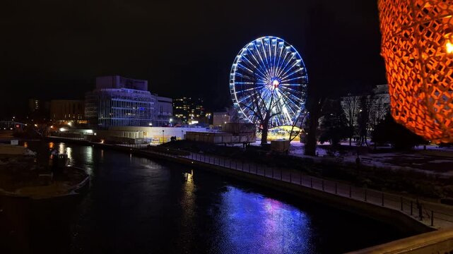 Colorful Big Wheel Ferris Reflections in River Brda at Night, Bydgoszcz, Kujavian Pomeranian, Poland