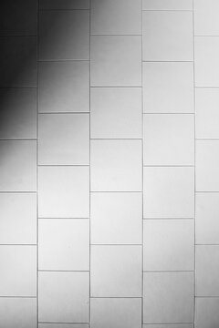 Minimalist White Ceramic Tile Wall Texture with Soft Natural Shadow