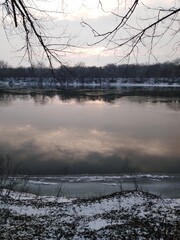 Winter river landscape with snow and forest