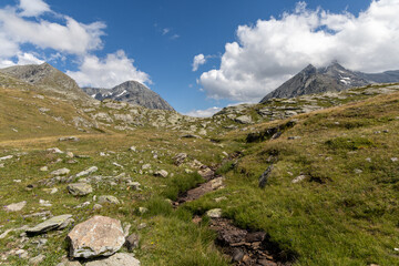 Panoramic mountain view of the Mont-Cenis Massif ,Savoie, French Alps, featuring rugged peaks, alpine meadows, and natural high-altitude scenery. © clement