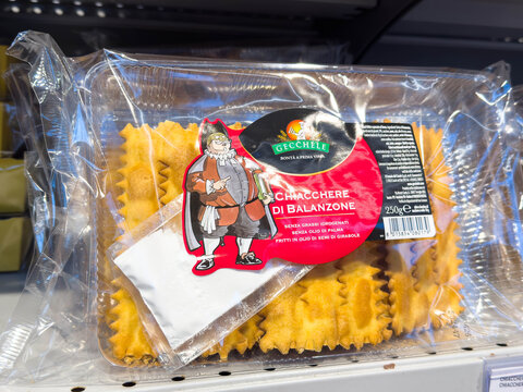 Tarvisio, Italy - January 15, 2026: Packaged Italian Chiacchiere di Balanzone pasta with colorful label and character illustration on display in a grocery store shelf