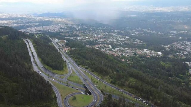 Stunning Aerial View of Simon Bolivar Avenue in Quito, Ecuador with Urban Traffic and Mountain Scenery