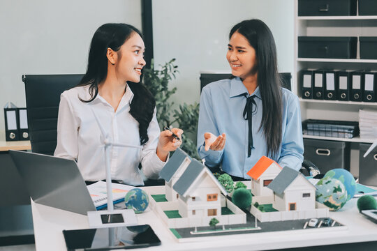 Hands of adult Asian business professionals analyzing ESG financial data and renewable energy project plans - Powered by Adobe