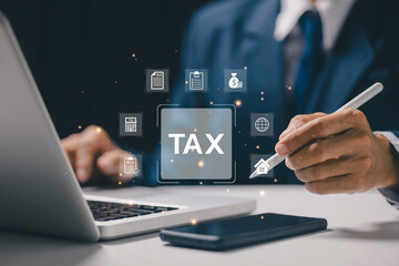Business professional managing digital tax interface on laptop with tax icons, representing tax planning, financial compliance, online tax filing, accounting management, and digital finance workflow.